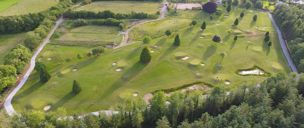 Drone ariel image of Newmarket's Pitch & Putt Course with IRD Duhallow's, James O'Keeffe Institute seen in the background with a beautiful sunset